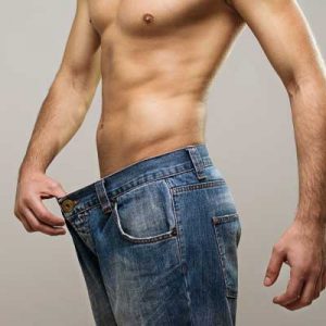 A man showing off his slim waist, following the weight loss programme.